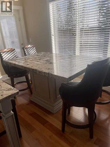 The island can be pulled away or removed - 113 Aspen Stone Place Sw, Calgary, AB - Indoor Photo Showing Other Room