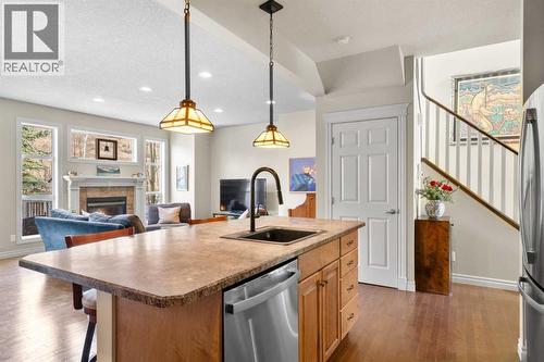 90 Discovery Ridge Gardens Sw, Calgary, AB - Indoor Photo Showing Kitchen With Fireplace With Upgraded Kitchen