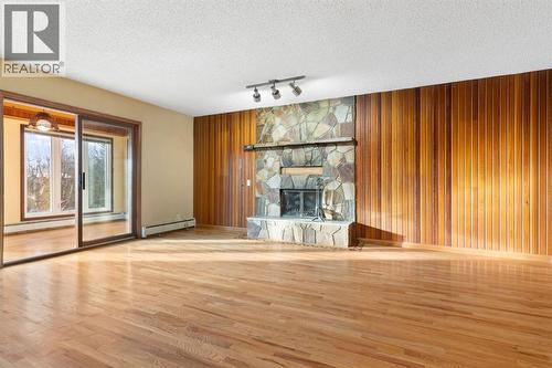 39 Coach Gate Way Sw, Calgary, AB - Indoor With Fireplace