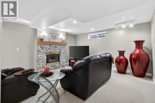 68 Bermondsey Rise Nw, Calgary, AB - Indoor Photo Showing Basement With Fireplace