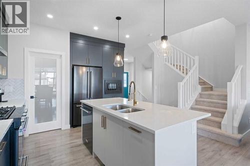 96 Emberside Glen, Cochrane, AB - Indoor Photo Showing Kitchen With Stainless Steel Kitchen With Double Sink With Upgraded Kitchen