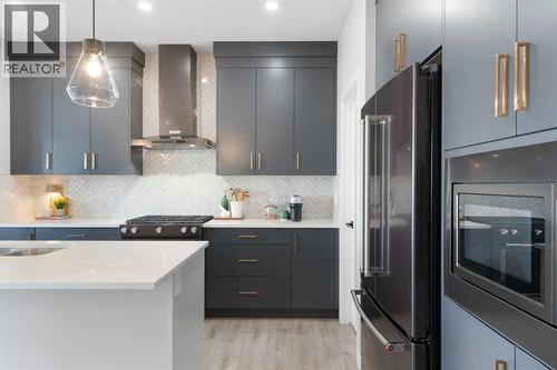 96 Emberside Glen, Cochrane, AB - Indoor Photo Showing Kitchen With Stainless Steel Kitchen With Upgraded Kitchen