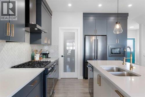 96 Emberside Glen, Cochrane, AB - Indoor Photo Showing Kitchen With Stainless Steel Kitchen With Double Sink With Upgraded Kitchen