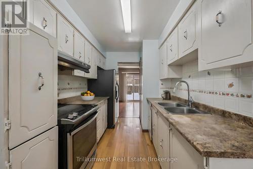 Virtually Staged - 49 - 900 Central Park Drive, Brampton (Northgate), ON - Indoor Photo Showing Kitchen With Double Sink