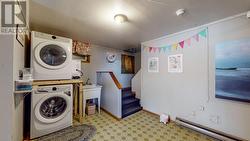 Laundry & storage at bottom of basement stairs - 