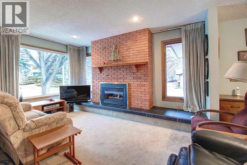 487 Arlington Drive Se, Calgary, AB - Indoor Photo Showing Living Room With Fireplace