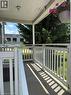 Covered front porch with white railings and vertical balusters - 13 Second Avenue E, Simcoe, ON 