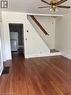 Open living area featuring new wood-finish flooring, white wall paint, and white baseboards - 13 Second Avenue E, Simcoe, ON 