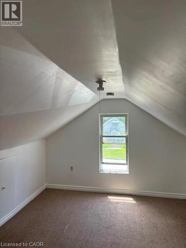 upstairs,featuring sloped ceilings,carpeted flooring - 13 Second Avenue E, Simcoe, ON 