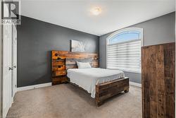 Bedroom featuring carpet flooring and baseboards - 