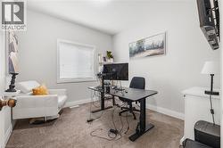 Home office featuring light carpet and baseboards - 