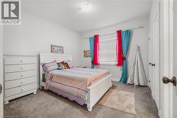 Carpeted bedroom with a textured ceiling and baseboards - 
