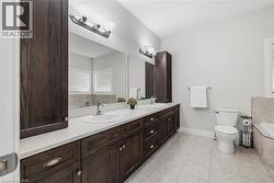 Full bathroom with double vanity, a bath, and light tile patterned floors - 
