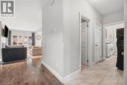 Corridor featuring washer and clothes dryer, recessed lighting, and light wood-style flooring - 
