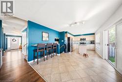 Kitchen with a center island, stainless steel appliances, light wood finished floors, open floor plan, and a textured ceiling - 