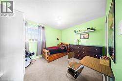 Carpeted bedroom featuring ceiling fan and a textured ceiling - 