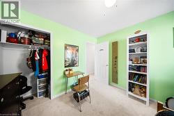 Carpeted bedroom featuring a desk and a closet - 