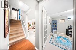 Hallway featuring light wood-type flooring and stairway - 