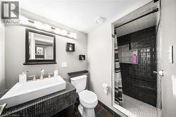 Bathroom with a stall shower and dark tile patterned floors - 