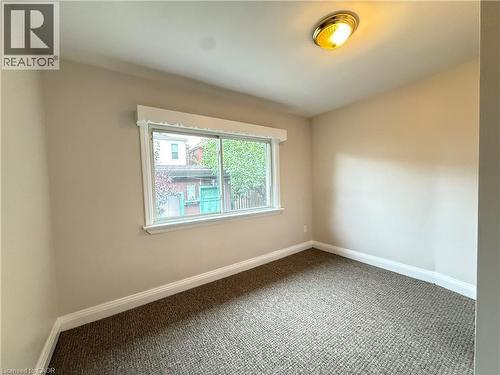 Carpeted empty room featuring baseboards - 24 Somerset Avenue, Hamilton, ON - Indoor Photo Showing Other Room