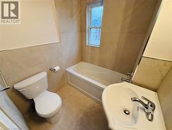 Bathroom featuring tile walls, a garden tub, and tile patterned floors - 