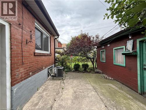 View of side of home with brick siding and a central air condition unit - 24 Somerset Avenue, Hamilton, ON - Outdoor With Exterior
