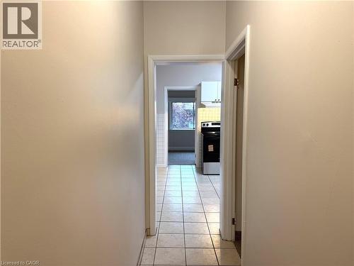 Corridor with light tile patterned floors and baseboards - 24 Somerset Avenue, Hamilton, ON - Indoor Photo Showing Other Room