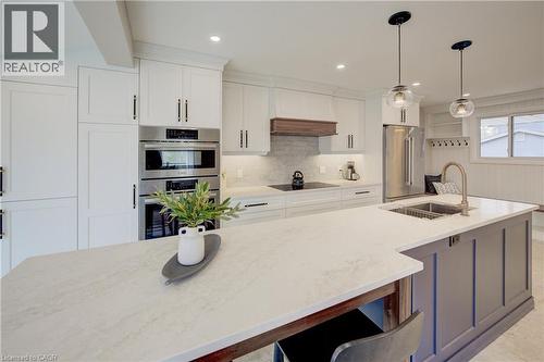 Kitchen featuring appliances with stainless steel finishes, decorative light fixtures, light stone countertops, white cabinetry, and recessed lighting - 279 Ferndale Place, Waterloo, ON - Indoor Photo Showing Kitchen With Double Sink With Upgraded Kitchen