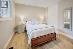 Bedroom featuring wood finished floors and baseboards - 