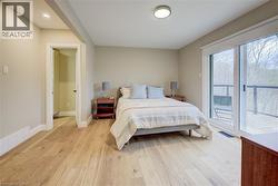 Bedroom with access to outside and light wood finished floors - 