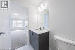 Half bath featuring vanity and light tile patterned floors - 