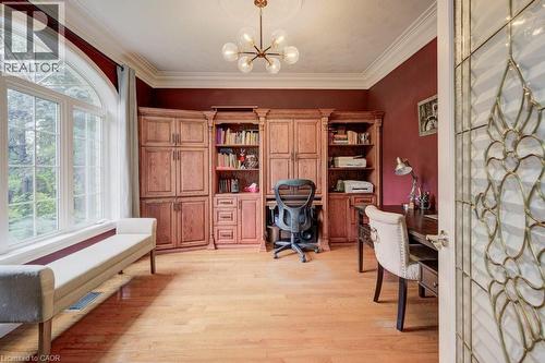 Office space featuring light wood-style floors, a chandelier, ornamental molding, and built in study area - 1525 Dickie Settlement Road, Cambridge, ON - Indoor Photo Showing Office