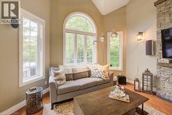 Living room with wood finished floors and high vaulted ceiling - 