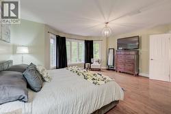 Bedroom featuring wood finished floors and baseboards - 