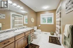Full bathroom featuring a bidet, vanity, tile patterned flooring, and a shower with curtain - 