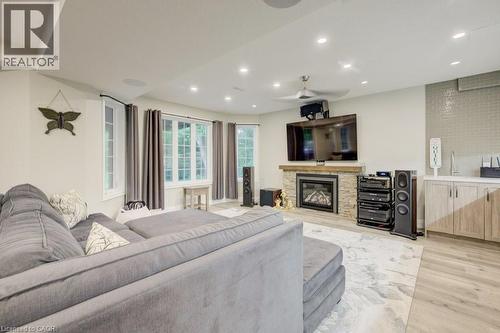 Living area with light wood-style flooring, recessed lighting, and a stone fireplace - 1525 Dickie Settlement Road, Cambridge, ON - Indoor Photo Showing Living Room With Fireplace