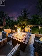 Deck at twilight featuring an outdoor fire pit - 