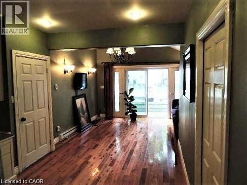 Corridor featuring a chandelier and dark wood-style flooring - 134 Courtland Avenue E, Kitchener, ON 
