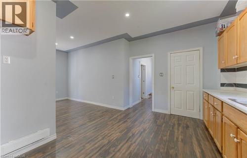 Kitchen with light brown cabinets, light countertops, recessed lighting, and dark wood finished floors - 138 Courtland Avenue E, Kitchener, ON 