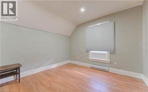 Additional living space with lofted ceiling, baseboard heating, light wood-style floors, and recessed lighting - 138 Courtland Avenue E, Kitchener, ON 
