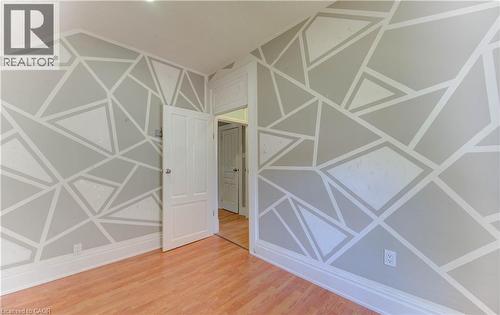 Empty room featuring light wood finished floors - 138 Courtland Avenue E, Kitchener, ON 