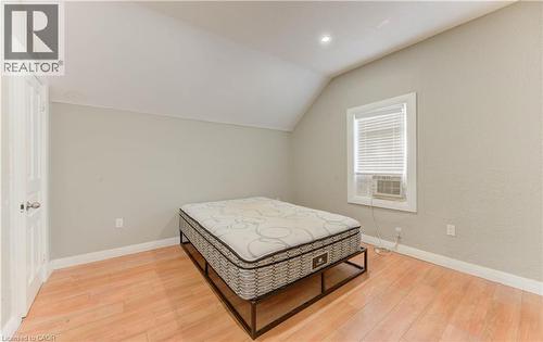 Bedroom featuring lofted ceiling, light wood-style floors, and recessed lighting - 138 Courtland Avenue E, Kitchener, ON 