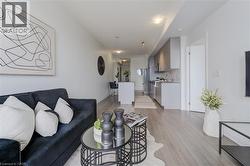 Living room with light wood-type flooring and baseboards - 