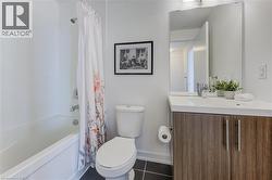 Bathroom with shower / bathtub combination with curtain, toilet, tile patterned flooring, baseboards, and vanity - 