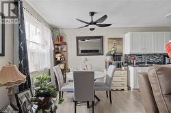 Dining area with light wood-type flooring and a ceiling fan - 
