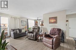 Living area with light wood-style floors and ceiling fan - 