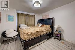 Bedroom with light wood finished floors - 
