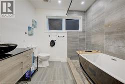 Bathroom with vanity, a garden tub, recessed lighting, tile walls, and walk in shower - 
