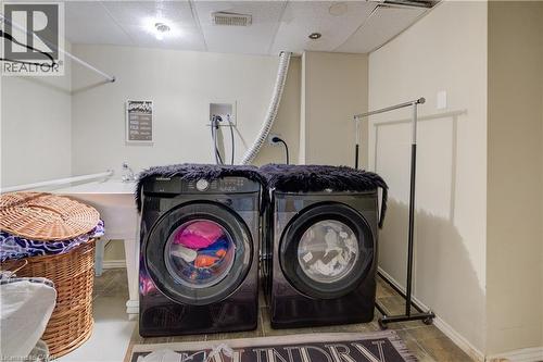Laundry area with washer and dryer and tile patterned flooring - 31 Bonfair Court, Kitchener, ON - Indoor Photo Showing Laundry Room