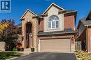 View of front of home with driveway, brick siding, a shingled roof, an attached garage, and stucco siding - 28 Springbreeze Heights, Hamilton, ON  - Outdoor With Facade 